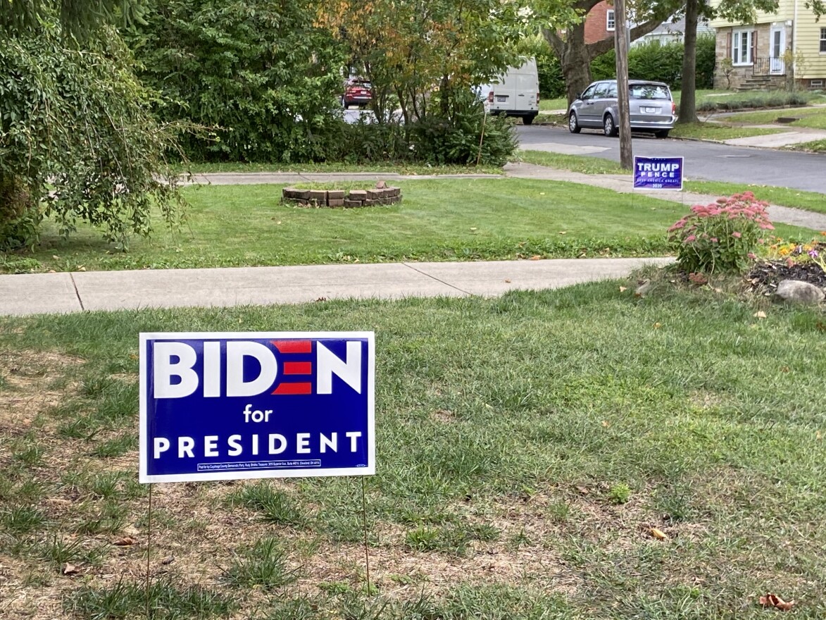 Neighbors on a street near the debate site at Case Western Reserve University have differing political viewpoints - and are demonstrating them with their yard signs.